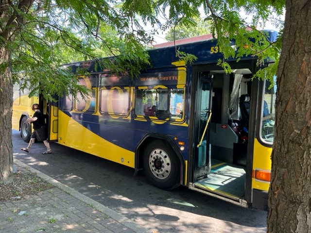 A Drexel shuttle bus parked on the side of the street